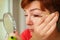 Close up portrait of caucasian Woman putting on brown mascara on eyelashes. She makes light day makeup