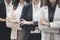 Close up portrait of cheerful businesswomen with arms folded standing in