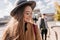 Close-up portrait of cheerful girl with straight hair walking across street with happy face expression. Glamorous fair