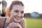 Close up portrait of cheerful smiling young girl with freckles on her face outdoors in sunny summer day. Human expressions and