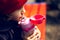 Close-up portrait of child girl drinking water from thermo bottle for kids.