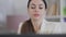 Close-up portrait of concentrated confident positive woman talking on video chat and smiling. Headshot of young