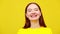 Close-up portrait of confident young woman with problematic skin and dental braces laughing out loud in slow motion