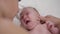 Close-up portrait crying newborn infant with teenage boy stroking ear talking hugging child. Dissatisfied Caucasian baby