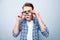 Close up portrait of curious teen man in street style wear narro