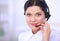 Close-up portrait of a customer service agent sitting at office