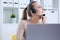 Close-up portrait of a customer service agent sitting at office propped her head by hand and dreaming.