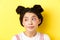 Close-up portrait of cute glamour asian girl, bright makeup and hairstyle, looking aside at logo with silly face, yellow