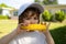 Close-up portrait of cute little child eating yellow sweet corncob corn. Autumn lifestyle. Homegrown organic food. Vegan