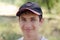 Close up portrait of a cute teenager in a baseball cap.