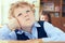 Close-up portrait of cute thoughtful schoolboy sitting at the desk and dreaming