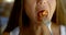 Close-up portrait of a dark-haired middle-aged woman sitting at a table, she eats, in front of her plate of salad, she