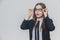 Close up portrait of a dazzling and astounded businesswoman, who is touching the black rim of glasses with both hands