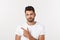 Close up portrait of disappointed stressed bearded young man in shirt over white background.