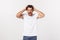 Close up portrait of disappointed stressed bearded young man in shirt over white background.