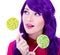 close up portrait of dreaming woman with purple hair and colorful lollipops