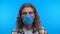 Close-up portrait, dumbfounded man in medical blue mask. man looks into the camera. 4K