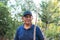 Close up portrait of an elderly indigenous latin farmer man holding a garden scraper.