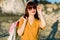 Close up portrait of elegant glamour young woman in sunglasses and yellow clothes, smiling with shopping bags outside