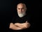 Close up portrait of an elegant senior man with grey hair isolated on black background. Confident Serious Senior Man