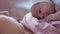 Close Up Portrait Face Newborn Naked Baby On Mom's Chest After Childbirth. Mother Holding Baby Child After Labor In