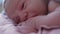 Close Up Portrait Face Newborn Naked Baby On Mom's Chest After Childbirth. Mother Holding Baby Child After Labor In