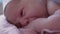 Close Up Portrait Face Newborn Naked Baby On Mom's Chest After Childbirth. Mother Holding Baby Child After Labor In