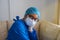 Close up portrait of a female nurse wearing a medical face mask, looking into the camera. Prevention of bacterial infection