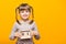 Close up portrait of first grader girl with funny pigtails smile looking at camera and hold wooden calendar set on 1 september