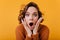 Close-up portrait of frightened girl with big brown eyes. Indoor photo of amazed european woman with short dark hair