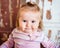 Close-up portrait of funny blond little girl with big grey eyes