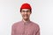 Close-up portrait funny cute bearded hipster guy in red beanie and glasses, smiling showing tongue playfully, having fun