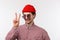 Close-up portrait funny and outgoing hipster man in red beanie, sunglasses and check shirt, getting ready summer