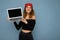 Close-up portrait of funny smiling happy beautiful dark blond young woman holding laptop computer looking at camera