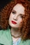 Close-up portrait of  girl, curly red hair, red lipstick, calm look, white skin, puffy hairstyle, evening make-up