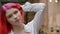 Close-up portrait of a girl with an unusual appearance and bright red hair. Young hipster woman mysteriously looks into