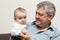 Close-up portrait of grandfather and grandson