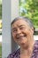 Close-up portrait of grandmother walking in park with her grandchildren, laughing looking at them