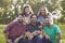 Close-up portrait of a group of friends in a summer park.