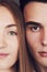 Close up portrait of half faces man and woman looking at camera