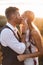 Close up portrait of handsome blond man and pretty woman in stylish boho rustic clothes, kissing. Lovely couple in eco
