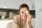 Close up portrait of happy, beautiful girl, chopping zucchini, smiling, posing in the kitchen while making food