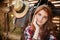 Close up portrait of a happy beautiful redhead cowgirl resting