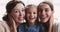 Close up portrait of happy beautiful three female generations family.