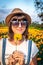 Close up portrait of happy and beautiful young woman relaxing enjoying the fresh beauty of gorgeous orange marigold