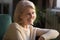 Close up portrait of happy elderly woman smiling looking away