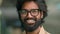 Close up portrait happy Indian bearded 30s businessman in eyeglasses male posing for camera. Handsome Arabian