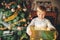 Close up portrait of happy little boy playing next to christmas tree