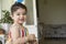 Close-up portrait of a happy little girl holding cleared plastic bottle in hands