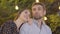 Close-up portrait of happy man and woman looking up and talking. Romantic Caucasian partners dating outdoors in summer